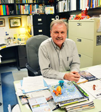 Dr. Donald Mykles sits in his office where he's collected crab-related items over the years.