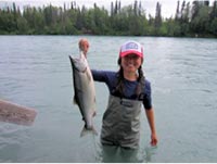 Lindsay Martin holds up a recently-caught salmon.