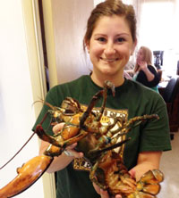 Megan Mudron poses with a lobster in the Bodega Marine Lab.