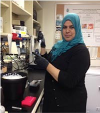 Nada Rifai stands near her lab bench.